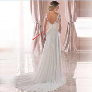 Detail of white lace wedding dress featuring deep V-back and elegant row of buttons