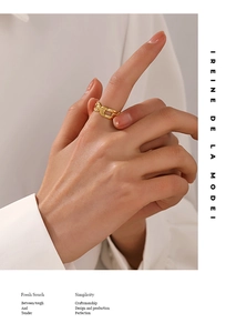 Detail of 18K gold-plated stainless steel chain ring on finger with glossy finish