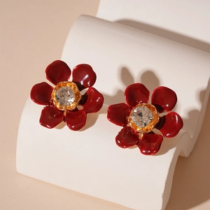 Vintage dark red enamel flower stud earrings with central crystal in a gold-plated finish