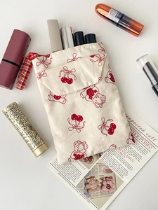 Close-up of canvas pouch with red bear print used as a lipstick makeup organizer