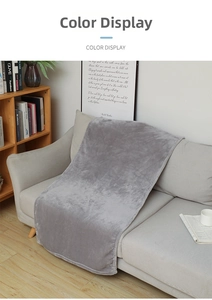 Close-up of grey flannel blanket texture draped on a sofa in a modern home interior