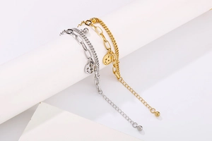 Detail view of double-layer stainless steel bracelets with hollow star pendant on stone stand
