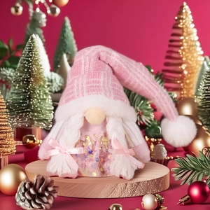 Pink sequin Christmas gnome with knitted hat and braids on festive wooden stand