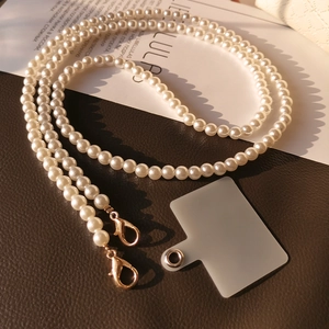 Crossbody pearl phone lanyard with gold metal lobster clasps and frosted patch connector