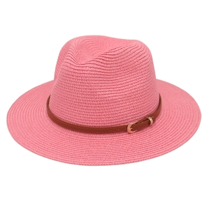 Close-up of pink woven Panama hat texture and brown leather belt with gold buckle