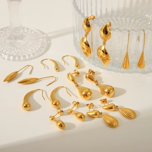 Collection of golden teardrop earrings and studs in polished stainless steel for women