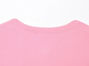 Detailed close-up of pink knit top neckline showing the round neck design and fabric texture