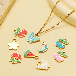Colorful enamel fruit pendants on gold chain including cherry and butterfly shapes