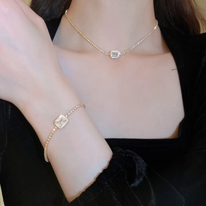 Close-up of luxury gold-plated square zircon necklace and bracelet set on model