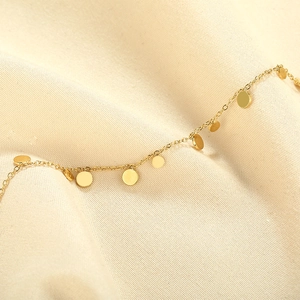 Elegant gold stainless steel necklace with polished disc pendants on thin O-chain