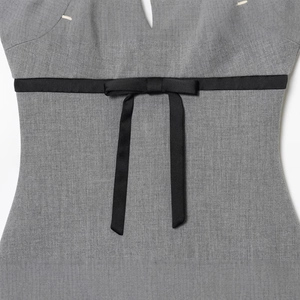 Elegant grey satin dress featuring a sleek black silk bow belt on the waistline