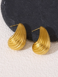 Macro shot of 18K gold plated teardrop stud earrings with textured stripe details