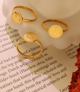 Detailed view of three 18k gold plated stainless steel rings with Fu character engraving