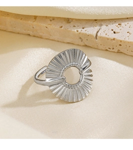 Detail of silver geometric pleated ring with hollow center on cream silk background