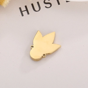 Detailed view of a gold clover charm connector with dual rings for DIY jewelry making