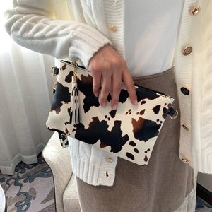 Fashionable cow print envelope clutch bag with leather tassel and gold hardware