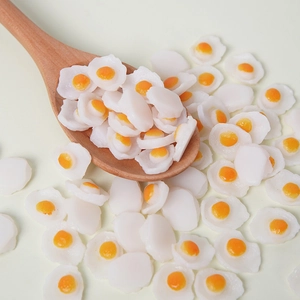 Miniature PVC fried eggs food props for dollhouse and DIY crafts on a wooden spoon