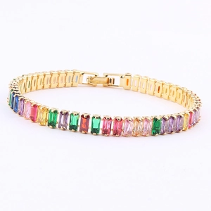 Detail of gold tennis bracelet featuring rectangular rainbow colored zircon stones