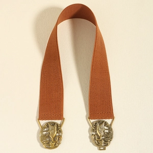 Detail of vintage bronze crane buckle and elastic woven band for women's waist belt