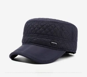 Detail view of navy blue quilted cadet cap showing diamond patterns and metal logo