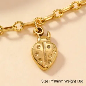 Detail of 17x10mm gold ladybug pendant with fine dotted texture and O-link chain