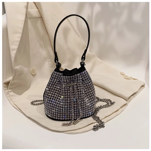Detailed view of a black rhinestone bucket bag with silver chain strap and drawstring