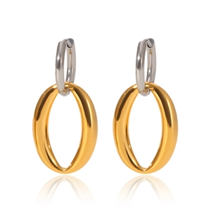 Detail of two-tone oval hoop earrings featuring gold and silver interlocking metal rings