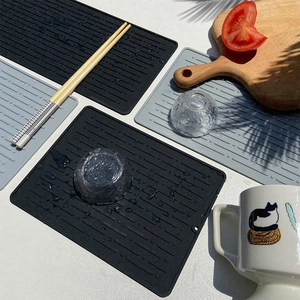 Large silicone dish drying mat in black and gray with non-slip striped texture for kitchen