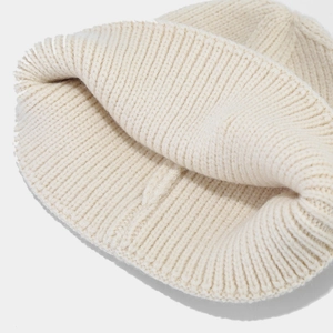 Creamy white ribbed knit beanie hat showing thick premium wool blend texture