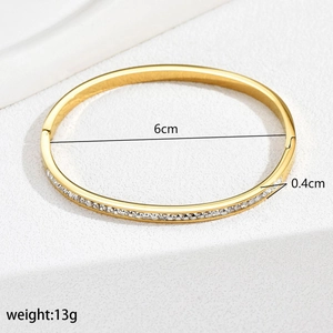 Detail view of gold stainless steel bangle with dimensions: 6cm inner diameter and 13g weight