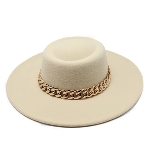 Detail of beige flat top wool hat featuring a bold gold link chain decorative band