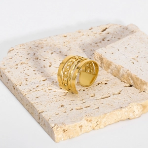 Detail of 18K gold plated multi-layer wide ring with Cuban chain design on stone