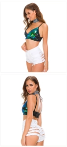 Close-up of white distressed denim shorts paired with a shimmering sequin halter top
