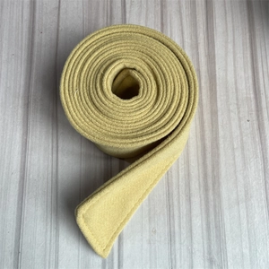 Detail shot of a yellow wool coat belt with visible fabric texture on grey background