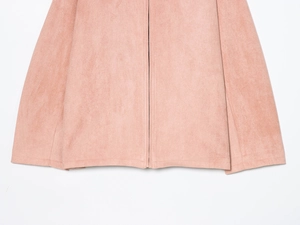Close-up of pink suede jacket featuring a high-quality metal zipper and hem stitching