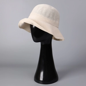 Detail of breathable cream woven paper bucket hat with elegant wavy brim and fine texture
