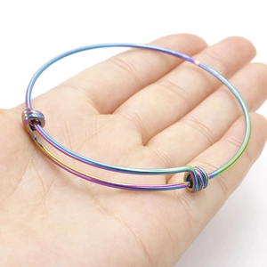 Close-up of a 1.8mm rainbow plasma stainless steel adjustable wire coil bracelet on hand