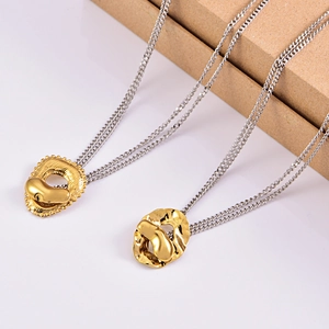 Mixed metal necklace featuring a gold heart pendant on silver chain over kraft box