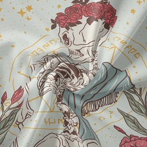 Detailed view of bohemian tarot tapestry fabric with skull and floral occult motifs