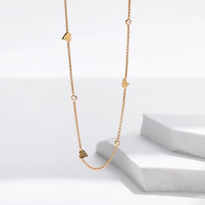 Detailed view of 18K gold plated chain with delicate heart charms and zircon stones