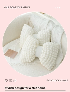 Macro view of cream bow-shaped decorative pillows with bubble texture on a sofa