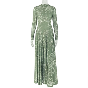 Detail of green mesh maxi dress featuring white leaf print and long sleeves texture