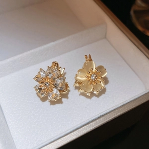 Close-up of double-sided flower stud earrings with opal stone and diamond details