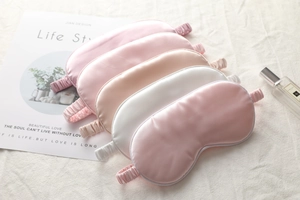 Detailed view of silk sleep masks in pastel colors with elastic bands and smooth texture