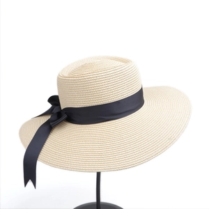 Women's minimalist wide-brim straw sun hat with black ribbon bow for beach and outdoor use