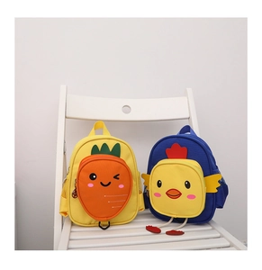 Detailed view of kids' cartoon canvas backpacks in carrot and chick designs on a chair