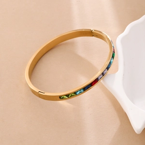 Elegant gold plated stainless steel hinge bangle with colorful rainbow gemstones