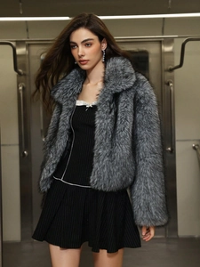 Gros plan sur la texture du manteau en fausse fourrure grise avec grand col en peluche
