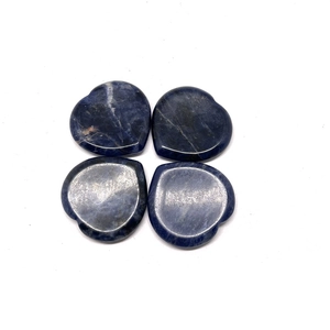 Detailed view of four heart-shaped blue sodalite worry stones with natural texture