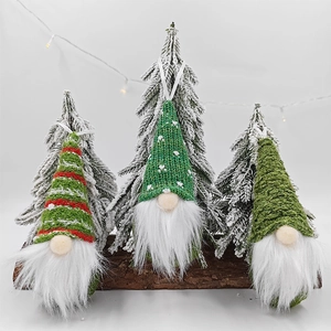 Three-piece knitted Christmas gnome ornaments with striped hats and white faux fur beards